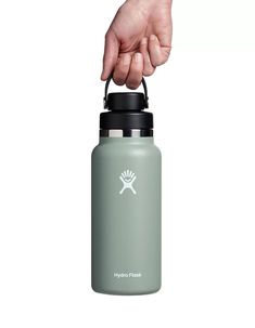 the hydro flask water bottle is being held by a hand