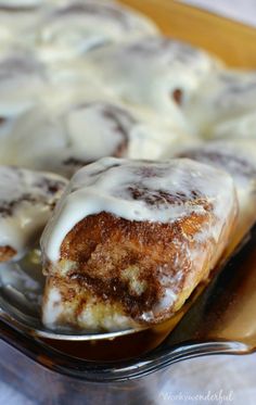 cinnamon roll with icing sitting on a plate