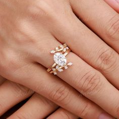 a woman's hand with two engagement rings on it