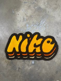 a skateboard with the word nice written in yellow and black on it's side