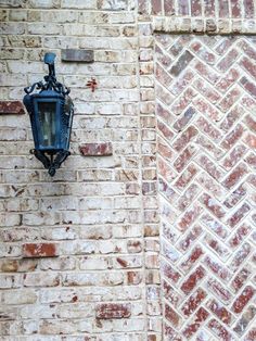 an old brick wall with a lamp on it