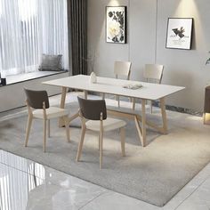 a white table with four chairs in front of a window