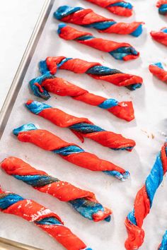 red, white and blue candy sticks on a baking sheet