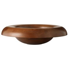 a wooden bowl sitting on top of a white surface