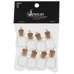 six small glass bottles with corks in them