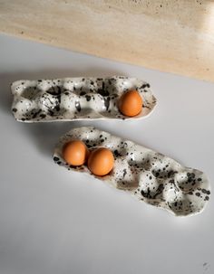 two eggs are in an egg carton on the counter