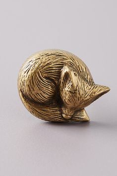 a gold colored animal figurine sitting on top of a table