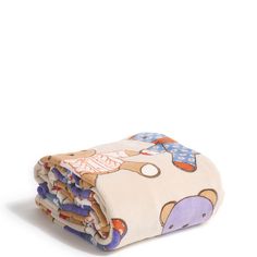 a blanket with an elephant on it is folded up in front of a white background