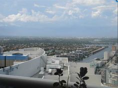 a view from the top of a building looking down on a river and buildings in the distance