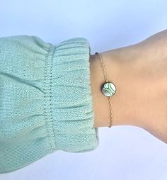 "Abalone Shell Bracelet ~ Silver or gold plated chain, 1\" extension chain to adjust. ~ Dainty natural abalone shell flat coin bead ~ Lobster clasp to close __SIZING__ Small      6\" shortest length Medium  7\" shortest length Large       8\" shortest length P R O D U C T I O N   T I M E S ~ Every single item in our shop is handmade to order with care!  ~ Please note that shipping time does not include production times. ~ Please see our shop policies for full details. C A R E   I N S T R U C T I Adjustable Dainty Mother Of Pearl Jewelry, Gold Abalone Shell Round Jewelry, Adjustable Mother Of Pearl Bracelets As Gifts, Adjustable Mother Of Pearl Bracelets For Gifts, Adjustable Mother Of Pearl Bracelet As Gift, Adjustable Abalone Shell Jewelry Gift, Adjustable Abalone Shell Jewelry For Gifts, Perle Plate, Abalone Shell Bracelet