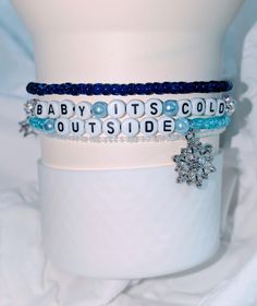 This stackable bracelet set is the perfect winter accessory. It features a classic wintery blue color scheme with ice blue and white beads, a sparkly snowflake, and a star charm. It's sure to add a touch of glamour to your favorite Stanley this holiday season. This handmade stack is sold as a set of 4. It will fit 30 and 40 oz Stanley's. Bracelets will slide on and stay secure with a boot. (Boot not included) Bracelets are made of elastic and are slightly stretchy. Be careful not to overstretch them. Gently roll the bracelets on to the cup and secure with boot. ❄️ Cute Bracelet Ideas, Winter Bracelet, Baby Its Cold, Cute Bracelet, Bracelet Inspo, Stanley Tumbler, Its Cold, Blue Color Schemes