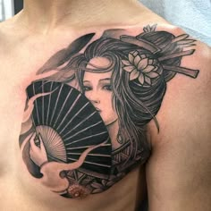 a woman with a fan tattoo on her chest is shown in black and grey colors