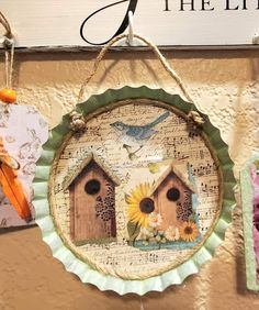 three birdhouses are hanging on the wall