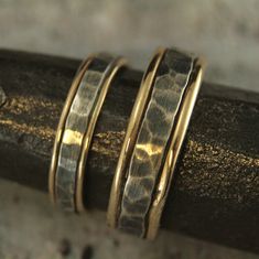 Bands Mixed Metal Rings Rustic Wedding Bands Mens Wedding Rings Womens Wedding Bands Two Tone Rings Hammered Wedding Set Paragon Blazer Arts Our Paragon Design is one of our most popular. It's rugged yet elegant, and now we have the perfect set for a couple who can be described that same way. To create your bands we will first securely solder full round 14K gold stock to both sides of a piece of rectangular silver stock. We then hand form this joined material into a ring just for you. The 14K go Handmade Elegant Couple Rings For Wedding, Handmade Gold Bridal Sets For Wedding, Adjustable Gold Wedding Bands, Adjustable Gold Bands For Wedding, Heirloom Wedding Bands Stackable, Heirloom Stackable Bands For Wedding, Heirloom Wedding Band Adjustable, Heirloom Stackable Wedding Bands, Hand Forged Ring Jewelry For Wedding