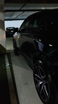 a black car parked in a parking garage