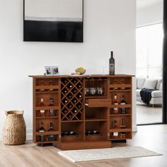 a wine rack with bottles and glasses on it in the middle of a living room