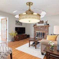 a living room filled with furniture and a flat screen tv on top of a hard wood floor