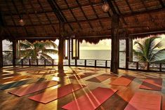 yoga mats are laid out on the floor in front of an open area overlooking the ocean