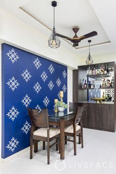 the dining room is decorated with blue and white snowflakes on the back wall