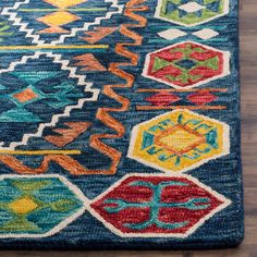 a blue rug with colorful designs on it