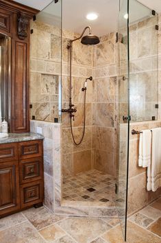 a walk in shower sitting inside of a bathroom