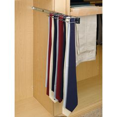 a tie rack with ties hanging from it's sides in front of a closet