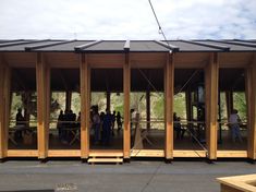 a group of people standing around a wooden structure