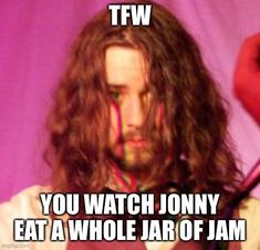 a man with long hair holding a knife in front of his face and the caption tfw you watch johnny eat a whole jar of jam