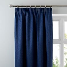 a blue curtain hanging in front of a window