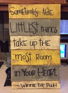 a wooden sign that says sometimes the littlest things take up the most room in your heart