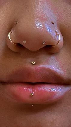 a woman's nose with two piercings on her nose and the bottom part of her nose