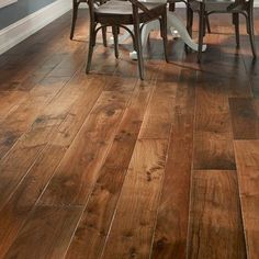 a dining room table and chairs with wood flooring