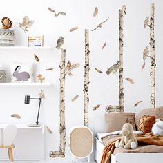 a bedroom with white walls and lots of birds on the tree trunk wall decals