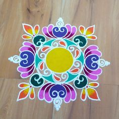 an image of a colorful design on the floor with wood floors in the back ground