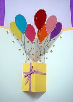 a gift box with balloons attached to it