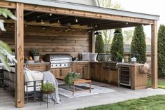 an outdoor kitchen with grill and seating area