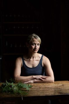 a woman sitting at a table with her arms crossed