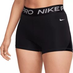 a woman in black shorts with the word pro nike printed on her bottom and side