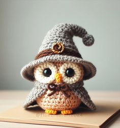 an owl with a hat on top of a book