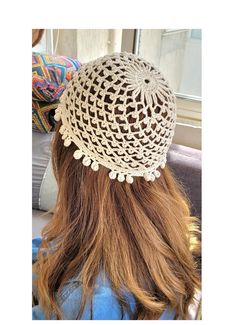 the back of a woman's head wearing a crocheted hat