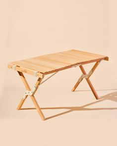 a wooden table sitting on top of a white floor