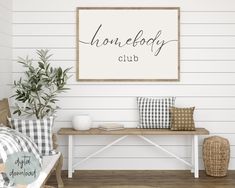 a room with a bench, pillows and a sign on the wall that says home body club