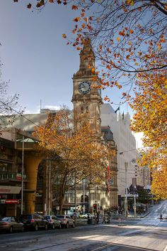 a large clock tower towering over a city street