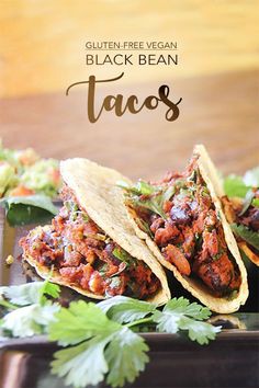 three black bean tacos on a plate with cilantro