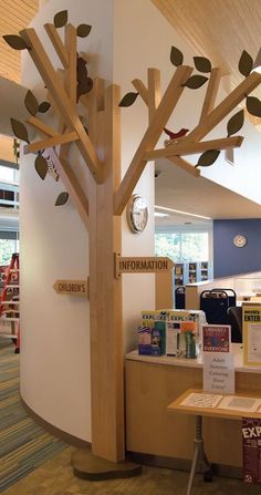 the inside of a children's book store with a tree