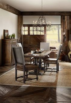 a dining room table and chairs in front of a fireplace