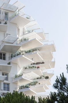 an apartment building with many balconies and plants on the balconies are shown