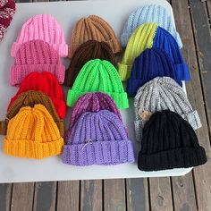 knitted beanies laid out on a white tray