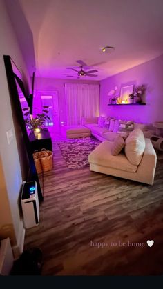 a living room filled with furniture and purple lighting