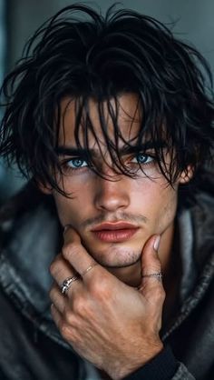 a man with long hair and blue eyes is posing for a photo in a leather jacket